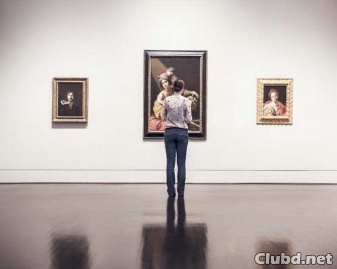 A girl looks at a picture in a museum - picture